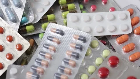 Pills in blisters rotating through shot in an overhead seamless loop Stock Footage 286218718