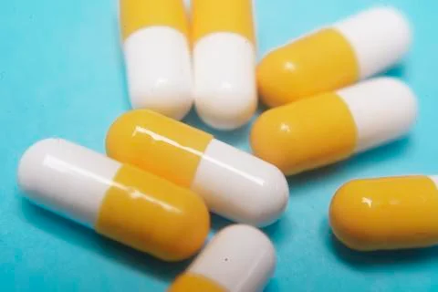 Pills on a blue background. Assorted pharmaceutical medicine pills, tablets a Stock Photos