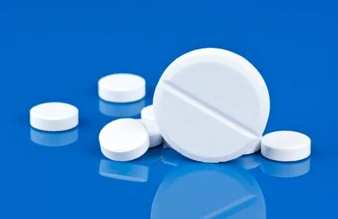 Pills on blue background Stock Photos
