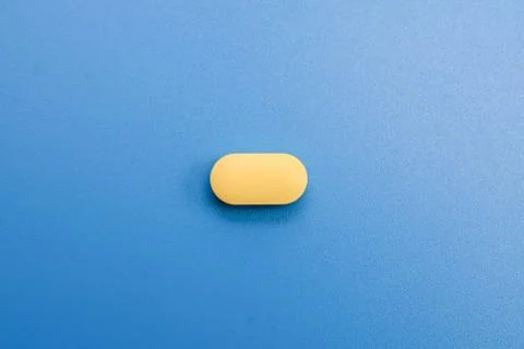 Pills on a blue background Stock Photos