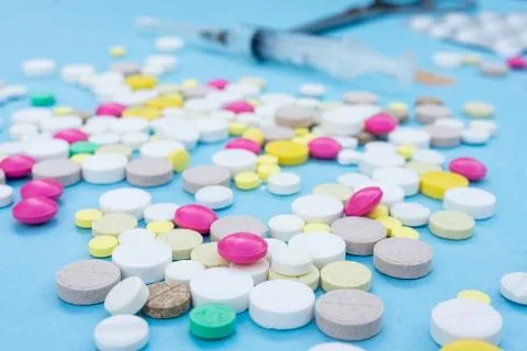 Pills on a blue background Stock Photos