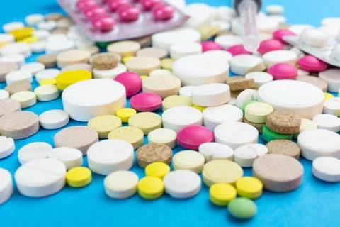 Pills on a blue background Stock Photos