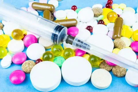 Pills on a blue background Stock Photos