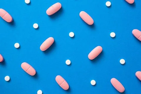 Pills on blue background Stock Photos