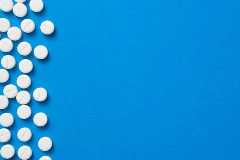 Pills on blue background Stock Photos