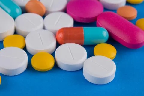 Pills on blue background 스톡 사진