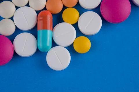 Pills on blue background 스톡 사진