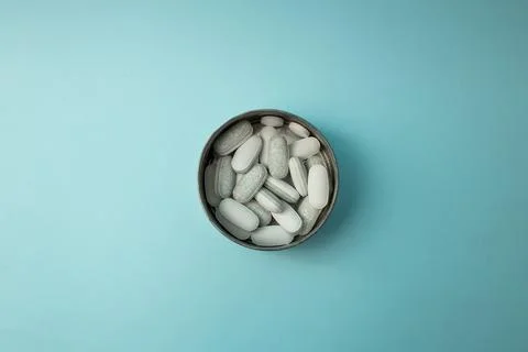 Pills on a blue background Stock Photos