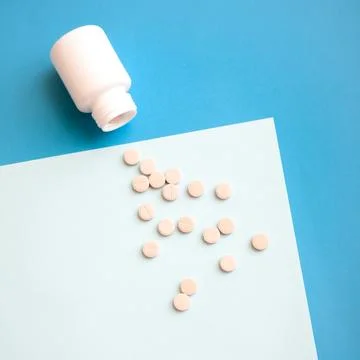 Pills on blue background Stock Photos