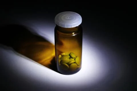 Pills bottle in dramatic light Stock Photos