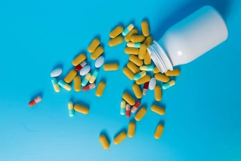 Pills from a bottle Stock Photos