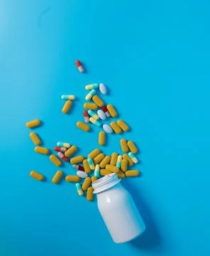 Pills from a bottle Stock Photos
