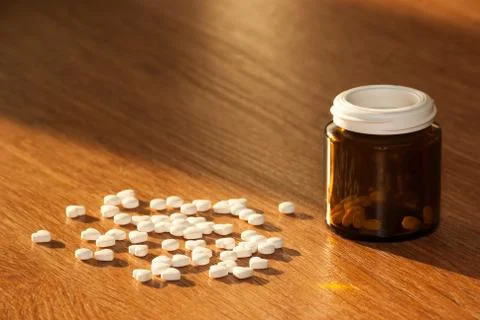 Pills with a bottle on the table Stock Photos