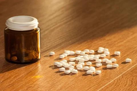 Pills with a bottle on the table Stock Photos