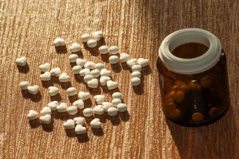 Pills with a bottle on the table Stock Photos