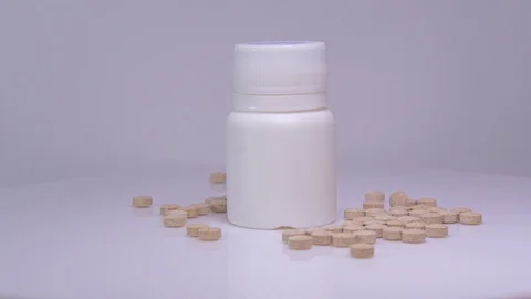 Pills with bottle on a white background Stock Footage 129607022