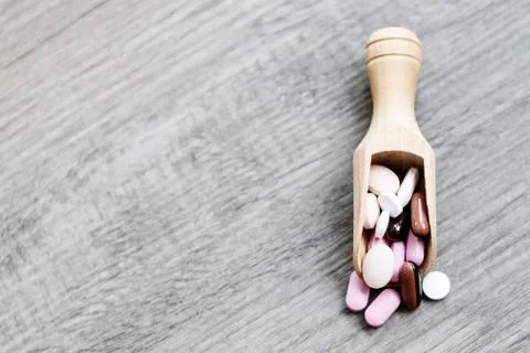Pills in the brown spoon Stock Photos
