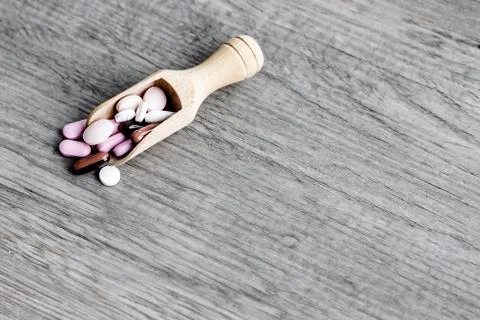 Pills in the brown spoon Stock Photos