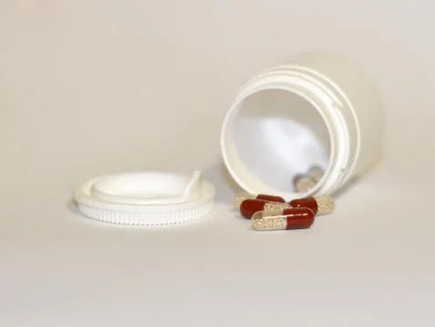 Pills in capsule on grey background Foto stock