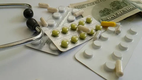 Pills capsule pen falling dollars Stock Footage 88494386