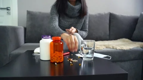 Pills, capsules and thermometer on the table. Woman taking medication. Stock Footage 100258479