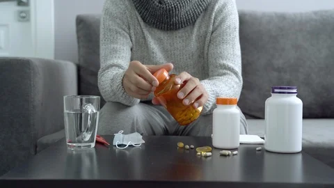 Pills, capsules and thermometer on the table. Man taking medication. Stock Footage 110806175