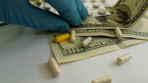 Pills capsules falling dollars, hand, glove Video stock 88494344