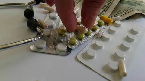 Pills capsules falling dollars, hand Stock Footage 88494368