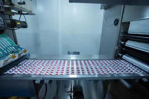Pills capsules manufacturing by a machine. automatic medicine tablet making mach Stock Photos