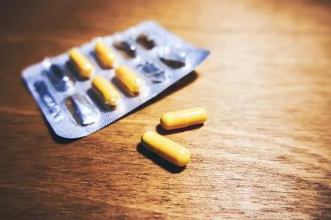 Pills in capsules on the table Stock Photos