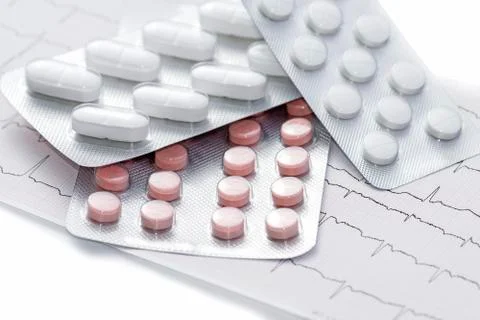 Pills on a cardiogram Stock Photos