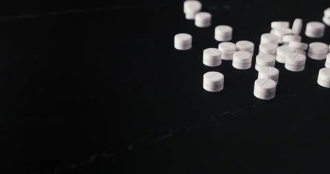 Pills crumbled on a black background Stock Footage 142235945