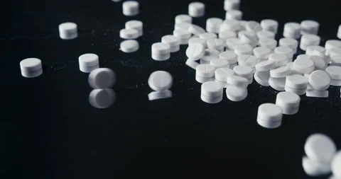 Pills crumbled on a black background Stock Footage 142236333