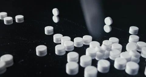 Pills crumbled on a black background Stock Footage 142236920