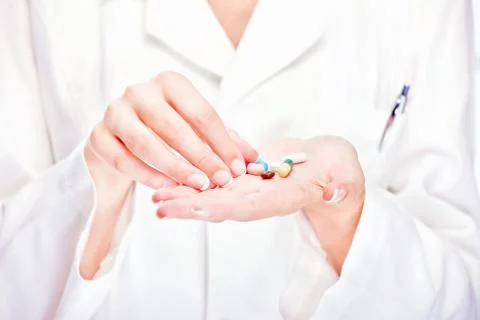 Pills in doctor's hands Stock Photos