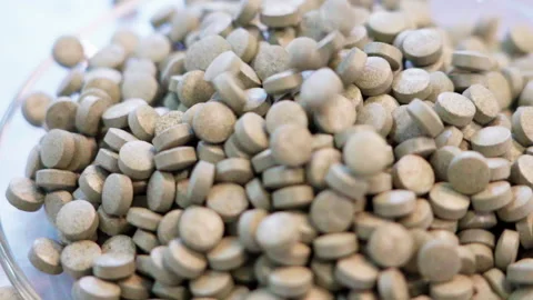 Pills dropping white background 50fps Video stock 156169292