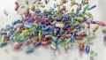 Pills drugs capsules falling on white table counter top slow motion closeup DOF HD Footage