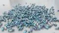Pills drugs capsules falling on white table counter top slow motion closeup 4K 4k or 4k+ Resolution