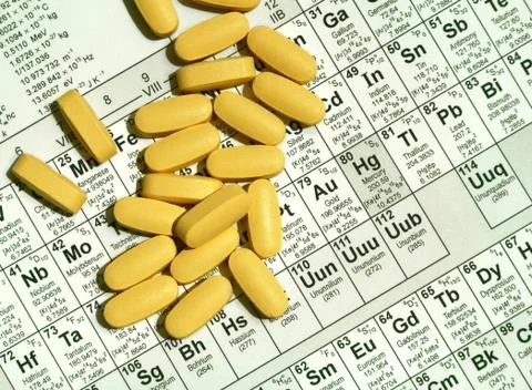 Pills on element table Stock Photos