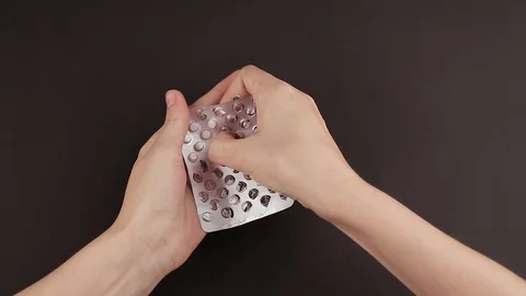 Pills extracts from a blister Stock Footage 85637249
