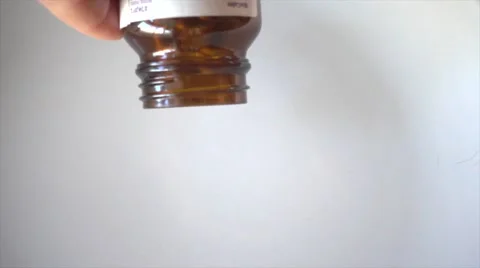 Pills fall from bottle in super slow motion Stock Footage 55861868