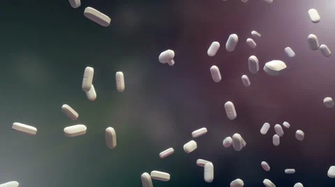 Pills fall down the screen in slow motion Stock Footage