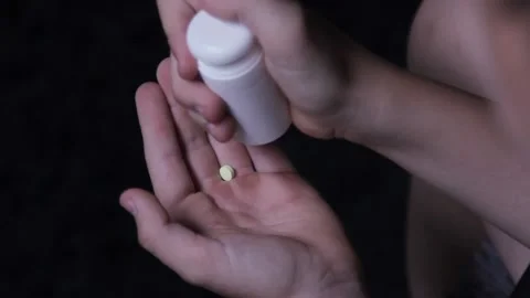 Pills fall into the hand on a dark depressive background Stock Footage 201519620