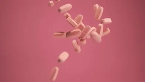 The pills fall on a pink background. Pink pills. Stock Footage 134896603