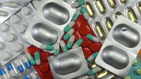 Pills fall on of rotating medications in 4K Video stock 140758332
