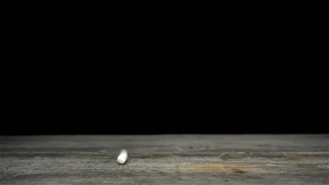 Pills fall in slow motion on a black Stock Footage 134309942