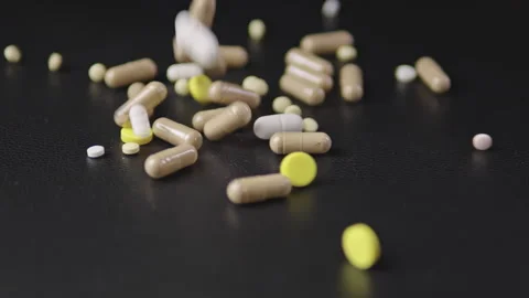 Pills fall in slow motion with lighting effects dust 스톡 동영상 329171315