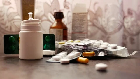 Pills fall on the table. Medicine Stock Footage 80125746