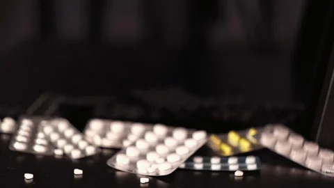 Pills falling on black background Stock Footage 125013822
