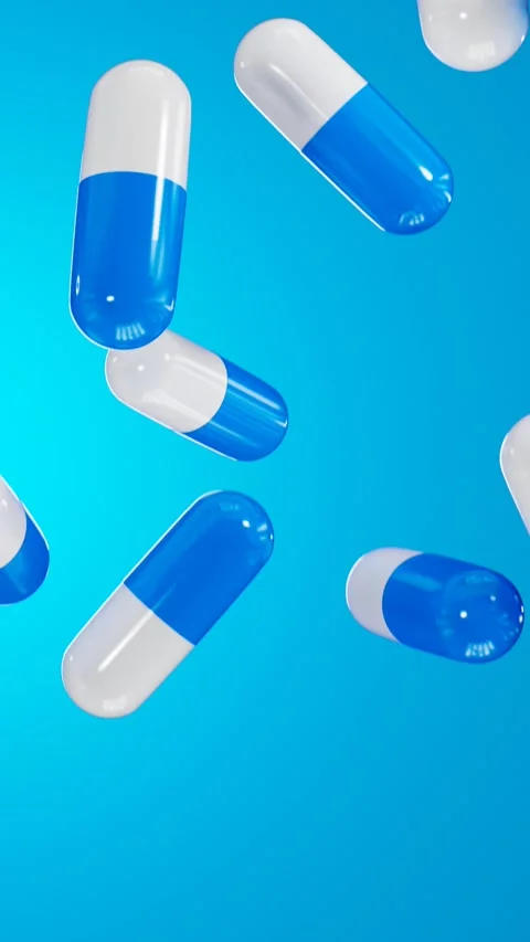 Pills falling on a blue background. 3D looped video Stock Footage 265809788